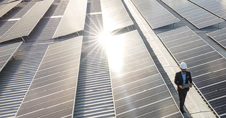 Electrical engineers are using laptops to monitor the operation of the solar rooftop  Renewable energy concepts