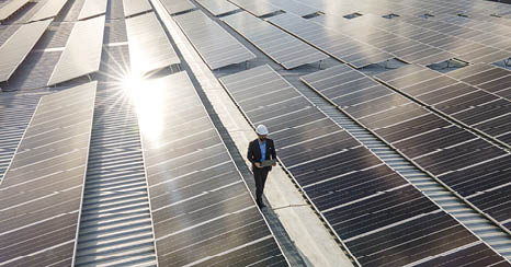 Electrical engineers are using laptops to monitor the operation of the solar rooftop  Renewable energy concepts