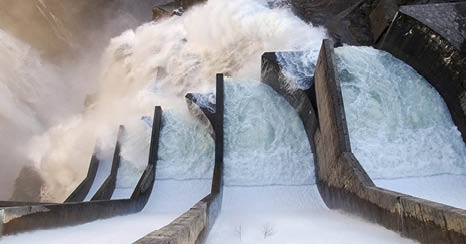 Dam of Contra Verzasca Ticino, Switzerland: spectacular waterfalls from the overflow of the lake