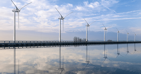 Allignement of wind turbines on water canal.