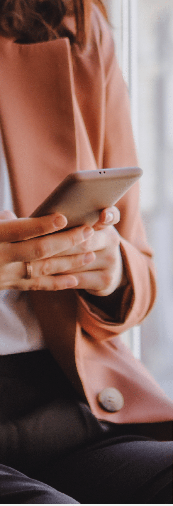 woman sitting in cafe texting on the phone crop close up copy space